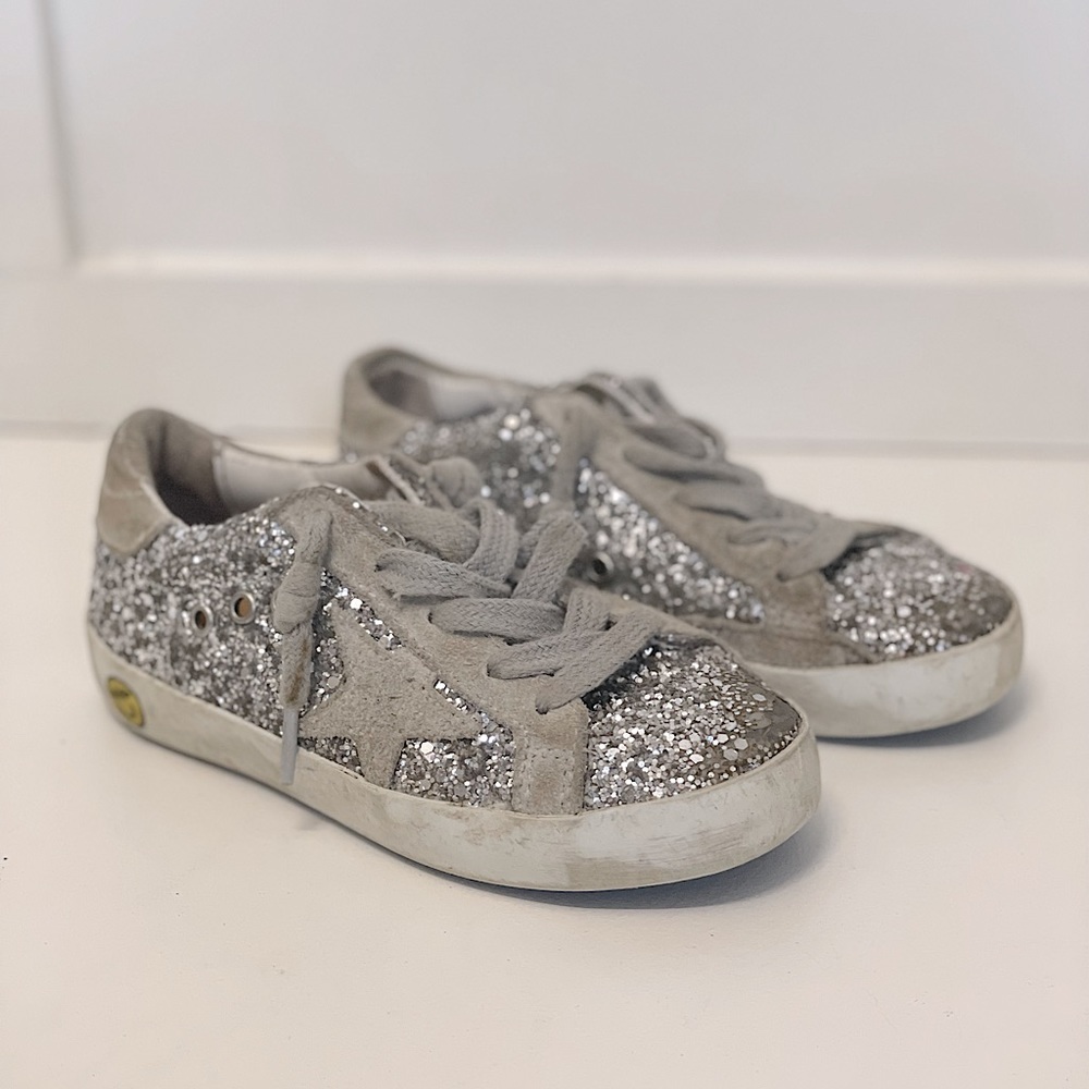 Kid’s Golden Goose Super-star low-top sneaker in silver glitter.